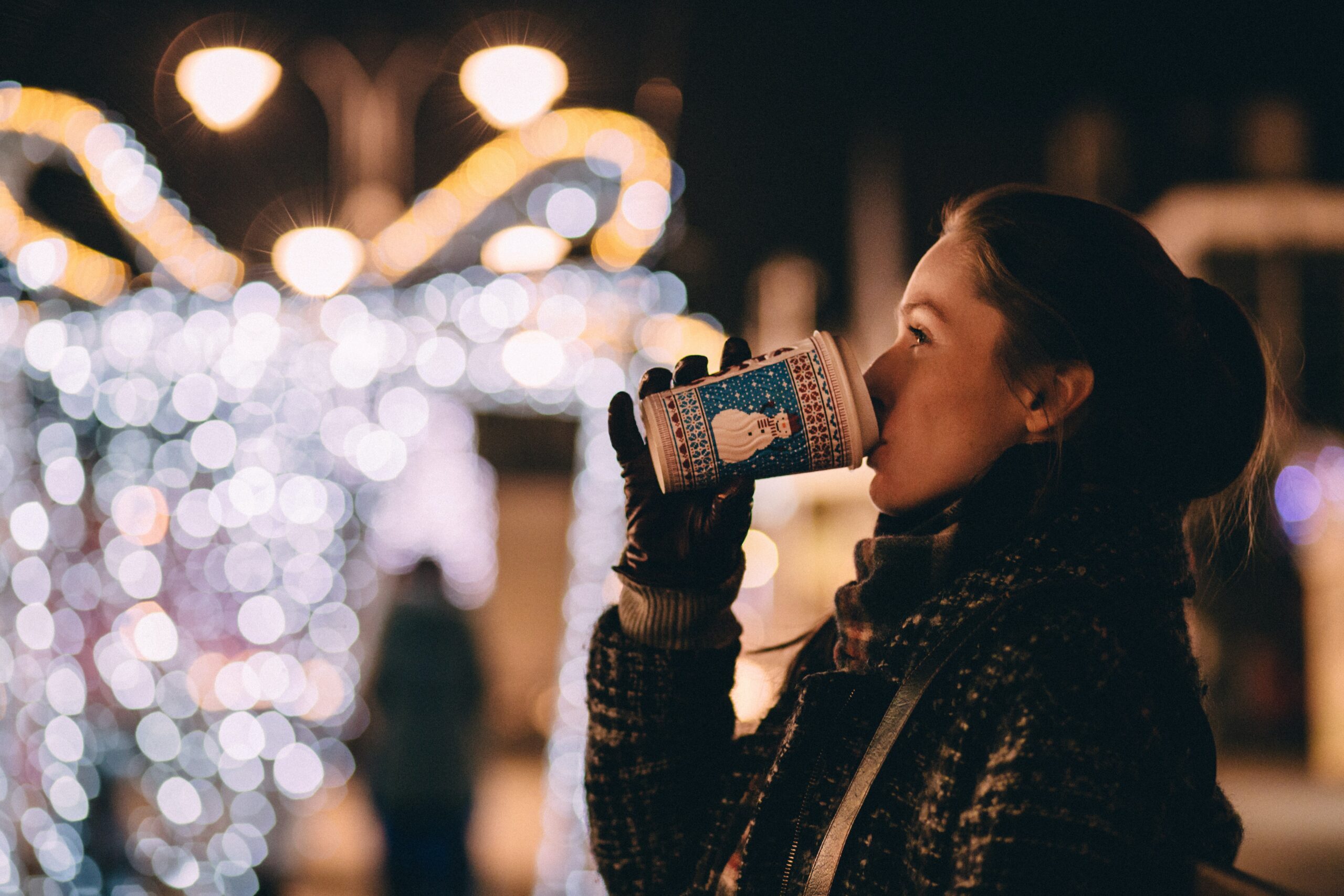 Woman in front of Christmas decorations enjoying a break which is one of the anxiety relief tips.