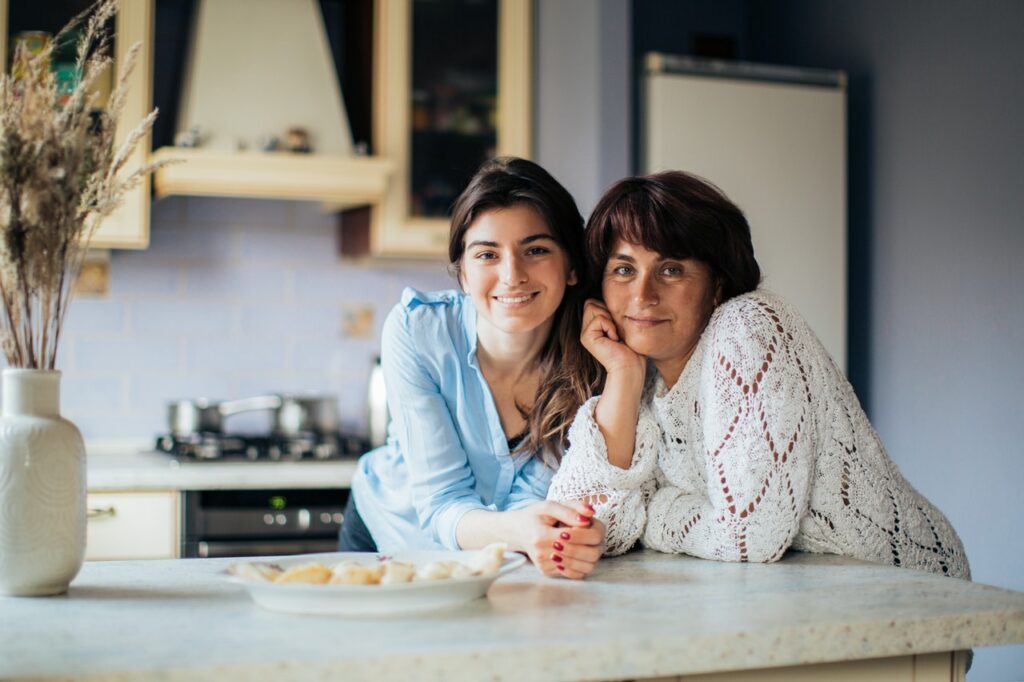 Mom and daughter smiling together and moving forward after a bad parenting moment