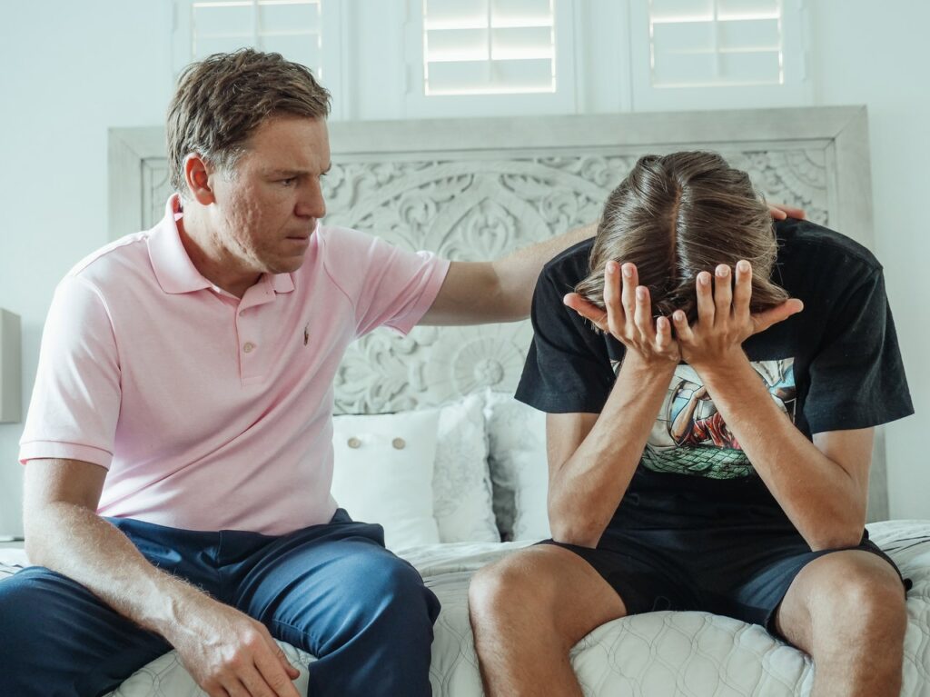 Father sitting with his son working through a family conflict.