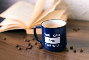 Blue coffee mug with the inspirational anxiety relief quote, "You can and you will." written on it.