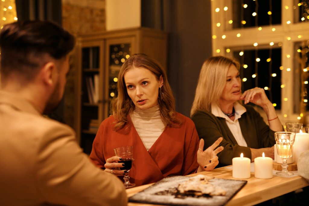 Woman dealing with stressful family members while sitting at a table.