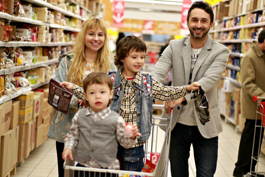 Young family at the grocery store coping with stressful family life.