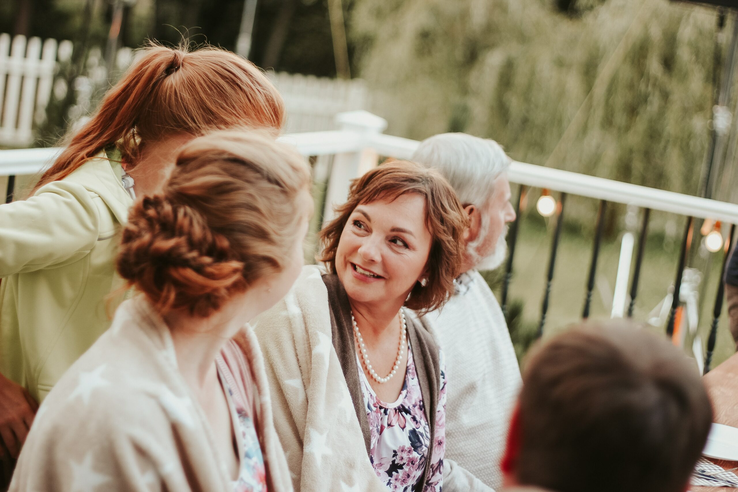 Smiling woman surrounded by her family helping her to cope with stressful life transitions.