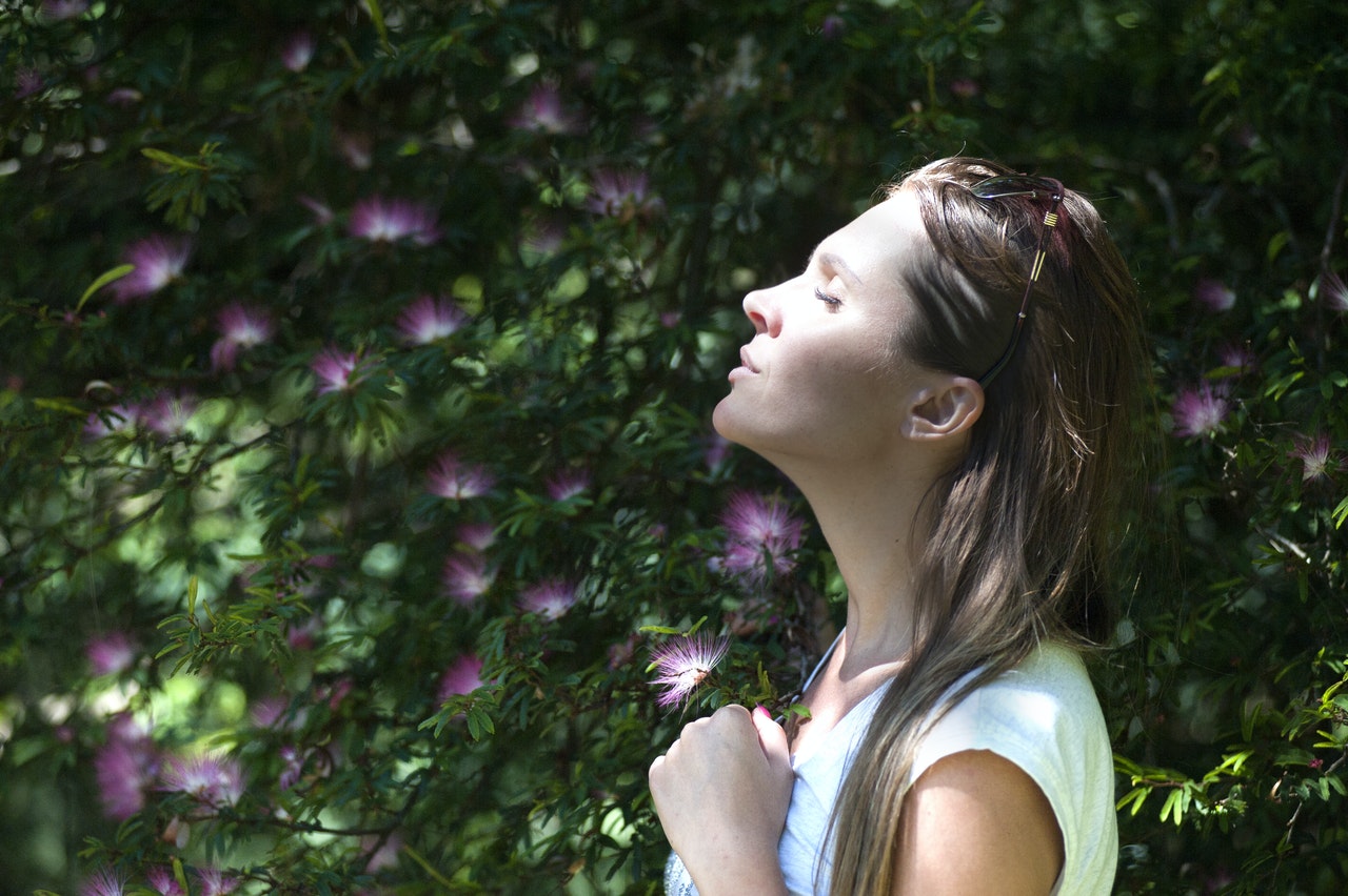 Woman outside using nature to ease her anxiety and depression.