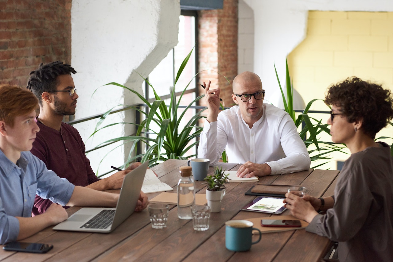 Co-workers sitting around a table using effective communication skills