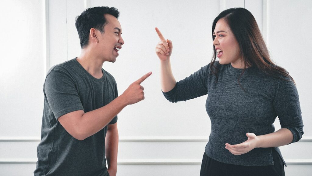 Asian man and woman in a disagreement needing healthy responses to conflicts in their relationship.